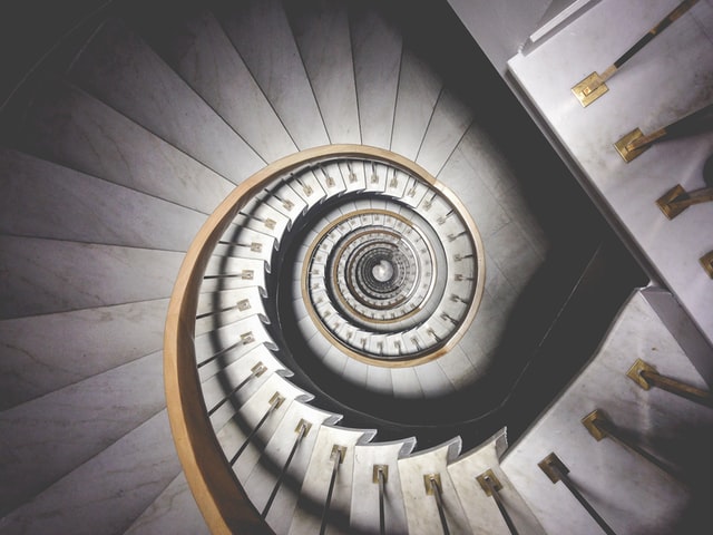Photo of spiral staircase by Ludde Lorentz (https://www.pexels.com/photo/empty-gray-and-white-concrete-spiral-stairs-3023211/)