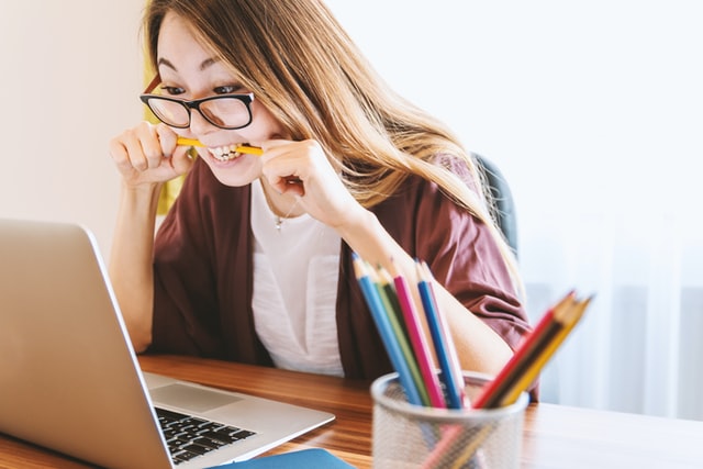 Image of woman biting pencil in front of computer by Jeshoots.com (https://unsplash.com/photos/-2vD8lIhdnw)
